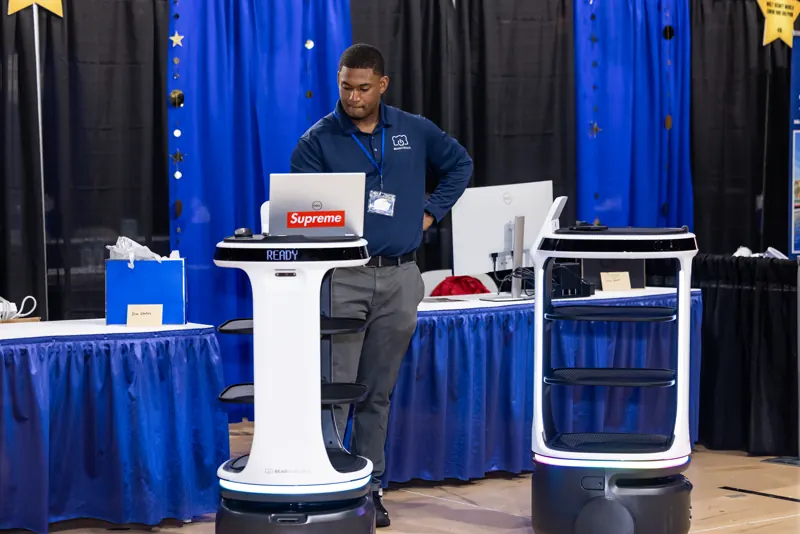 A Bear Robotics representative demonstrating autonomous service robots to Rosen College students