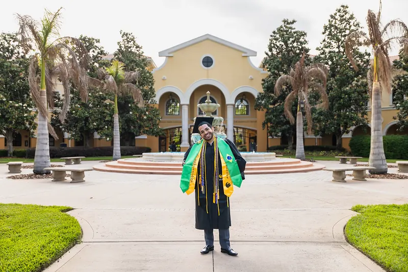 Rosen College graduates at the campus fountain